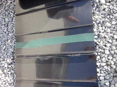 Root barrier sheet material along a gravel edge