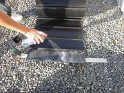 Backfilling gravel against installed root barrier sheet material
