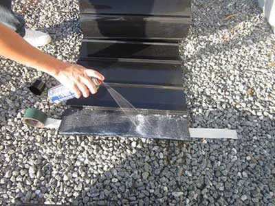 Backfilling gravel against installed root barrier sheet material