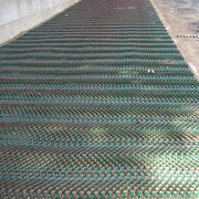 Tenax GP-Flex 1800 grass protection mesh installed across a fenced construction site area
