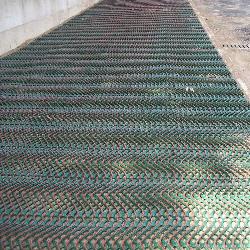 Tenax GP-Flex 1800 grass protection mesh installed across a fenced construction site area
