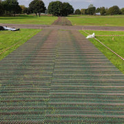 Cars parked on a grass overflow parking area reinforced with Tenax GP-Flex 1800 mesh
