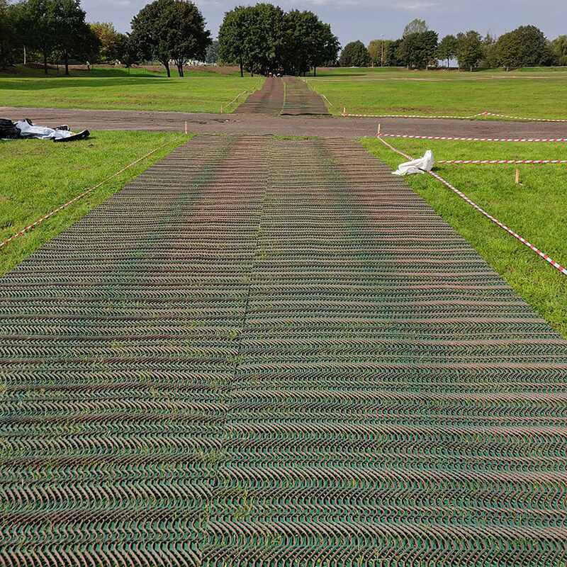 Cars parked on a grass overflow parking area reinforced with Tenax GP-Flex 1800 mesh
