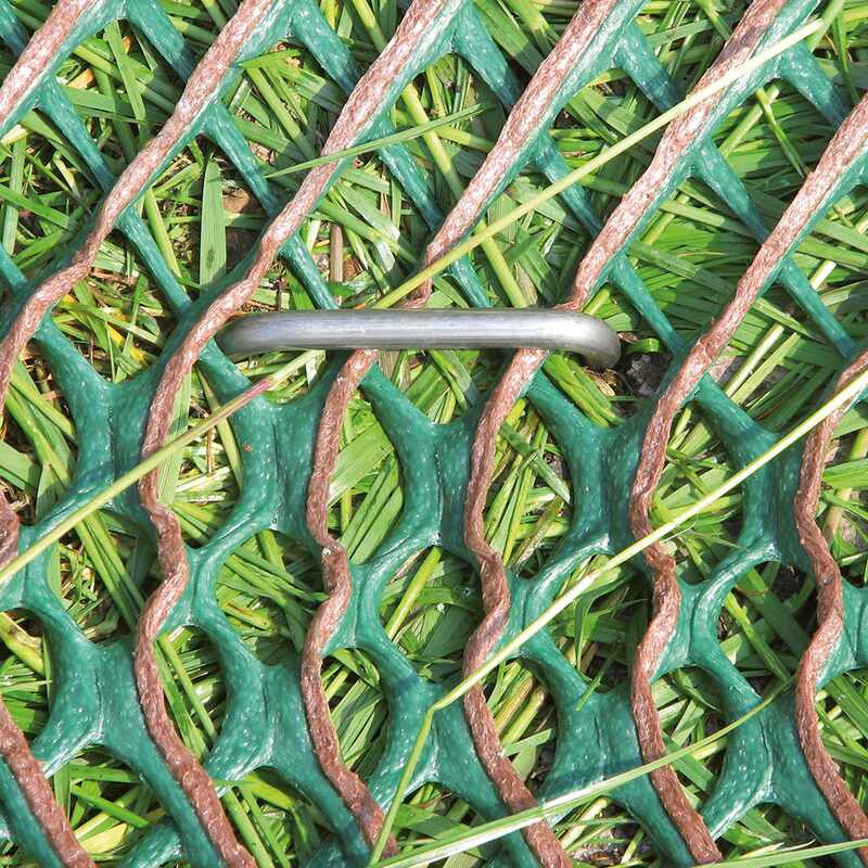 Close-up of heavy-duty Tenax GP-Flex 1800 grass protection mesh next to a parked car tire
