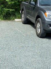 Pickup truck parked on a finished gravel paver driveway surface
