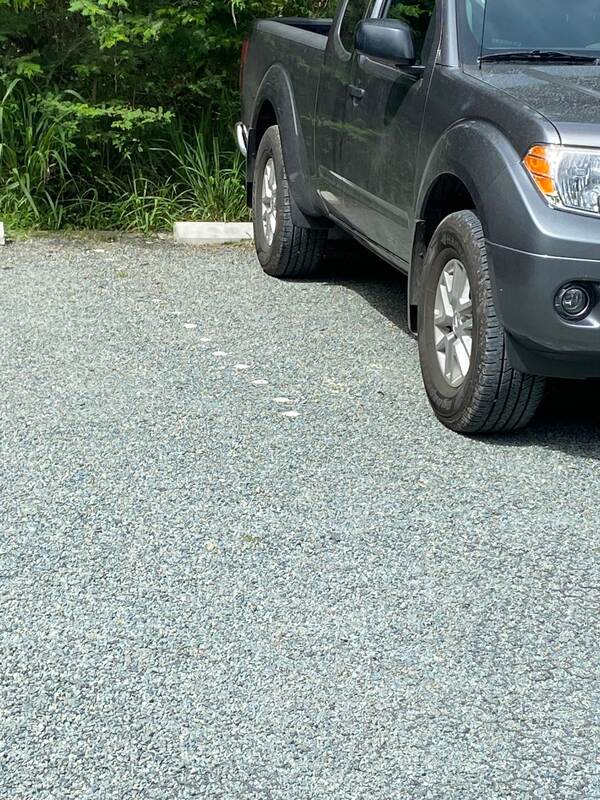 Pickup truck parked on a finished gravel paver driveway surface
