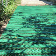 Newly installed Mudstop grass protection mesh covering a large area beside a fence
