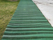 Mudstop grass protection mesh installed as a pathway between lawn and concrete driveway
