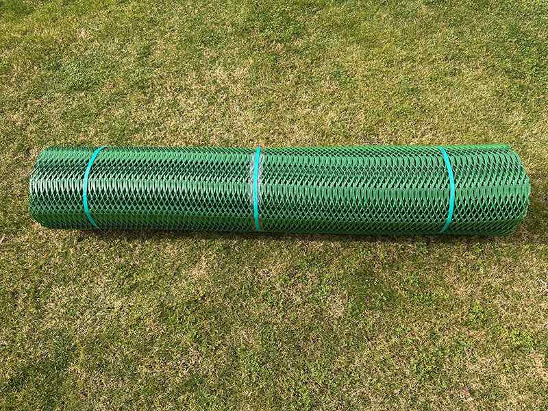 Close-up of a rolled Mudstop grass protection mesh roll showing diamond weave texture
