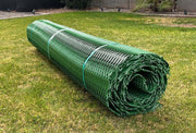 Rolled green Mudstop grass protection mesh product banded and staged on a lawn
