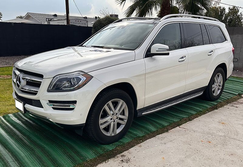 SUV parked on a driveway reinforced with Mudstop grass protection mesh, front view
