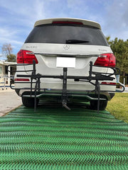 SUV parked on a driveway reinforced with Mudstop grass protection mesh, rear view
