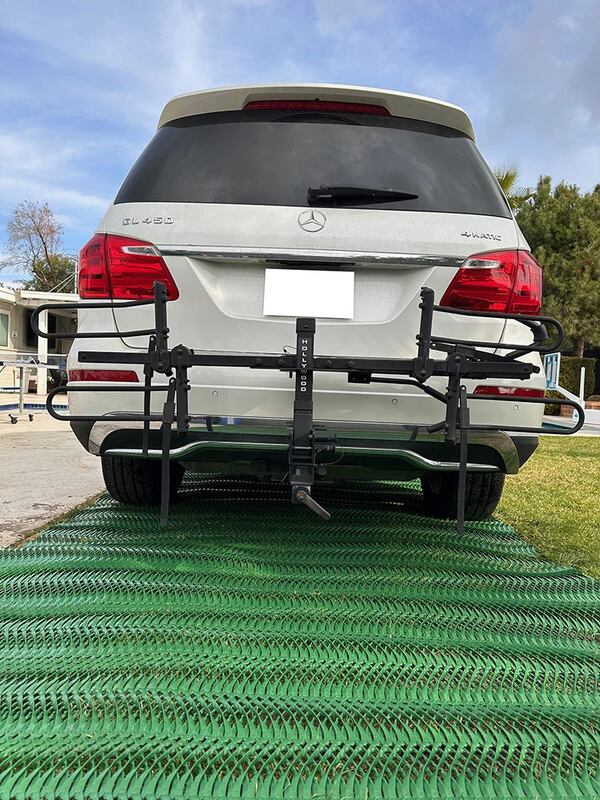 SUV parked on a driveway reinforced with Mudstop grass protection mesh, rear view
