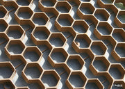 Close-up of NDS gravel paver grid in tan, showing the hexagonal cell pattern over geotextile fabric
