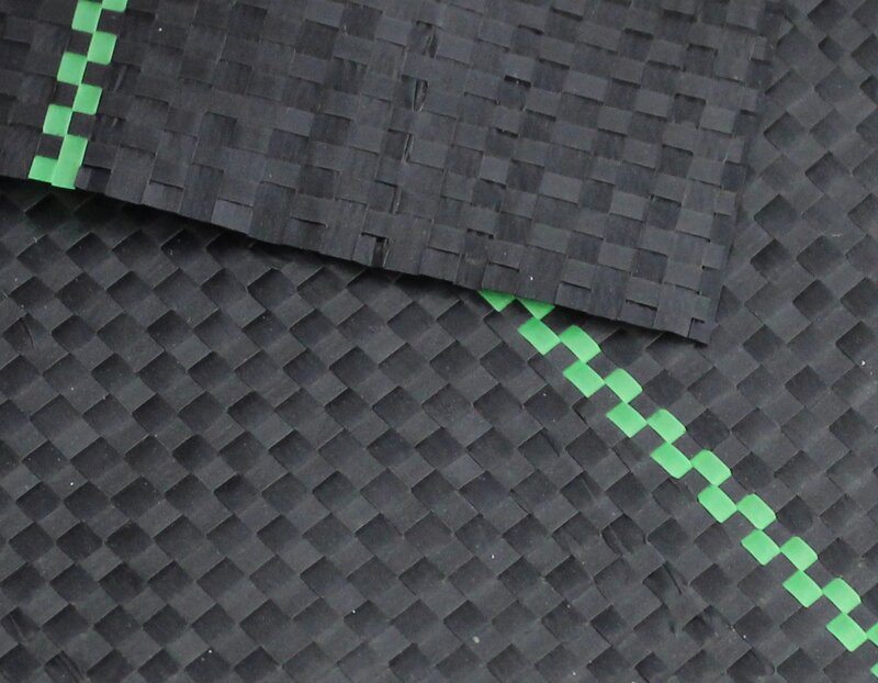 Close-up of woven ground cover fabric texture showing the seam between two overlapping panels
