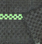Detailed close-up of woven ground cover fabric with a green marker stripe along the seam
